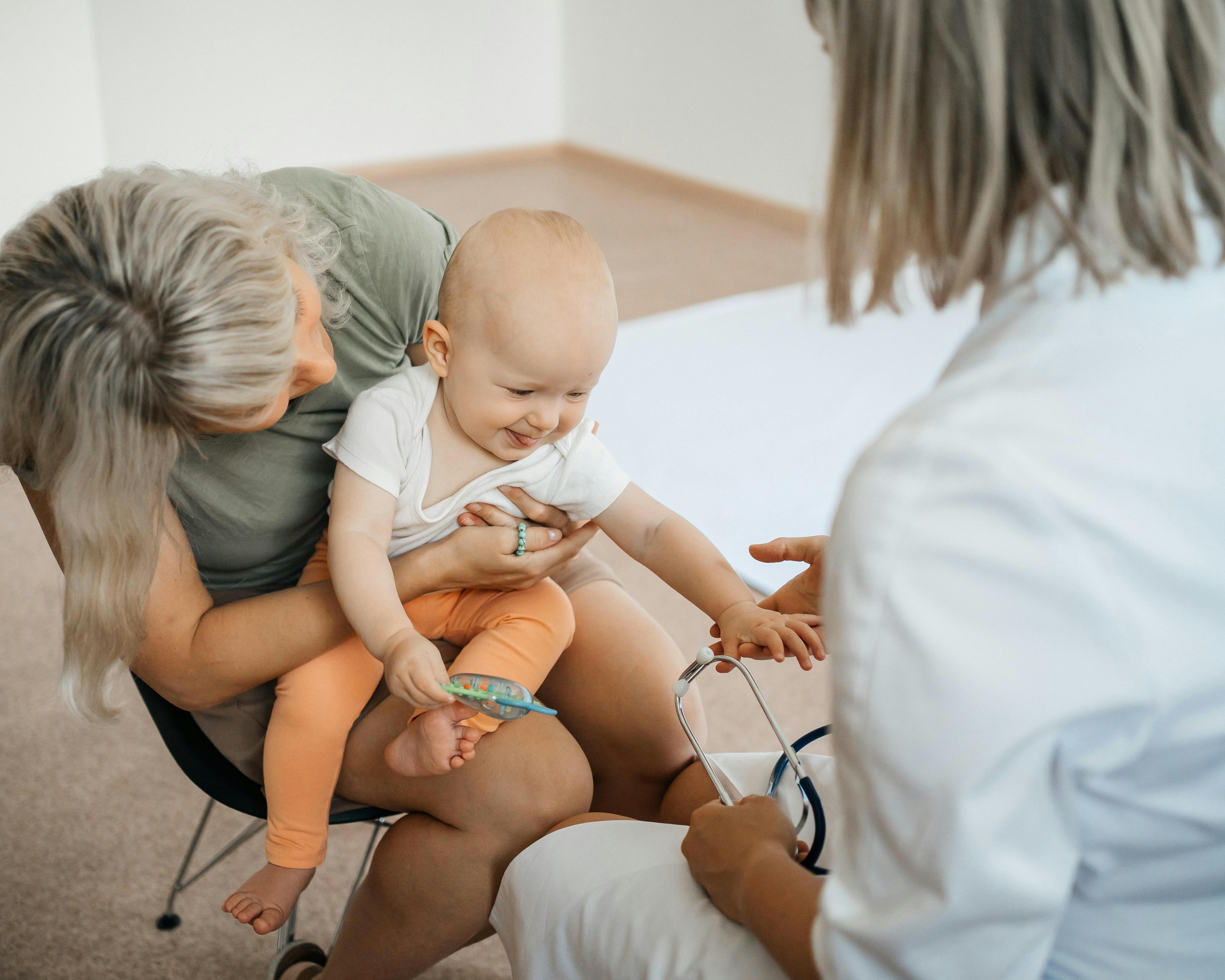 Female doctor pediatrician examines the baby 1444116909.jpg