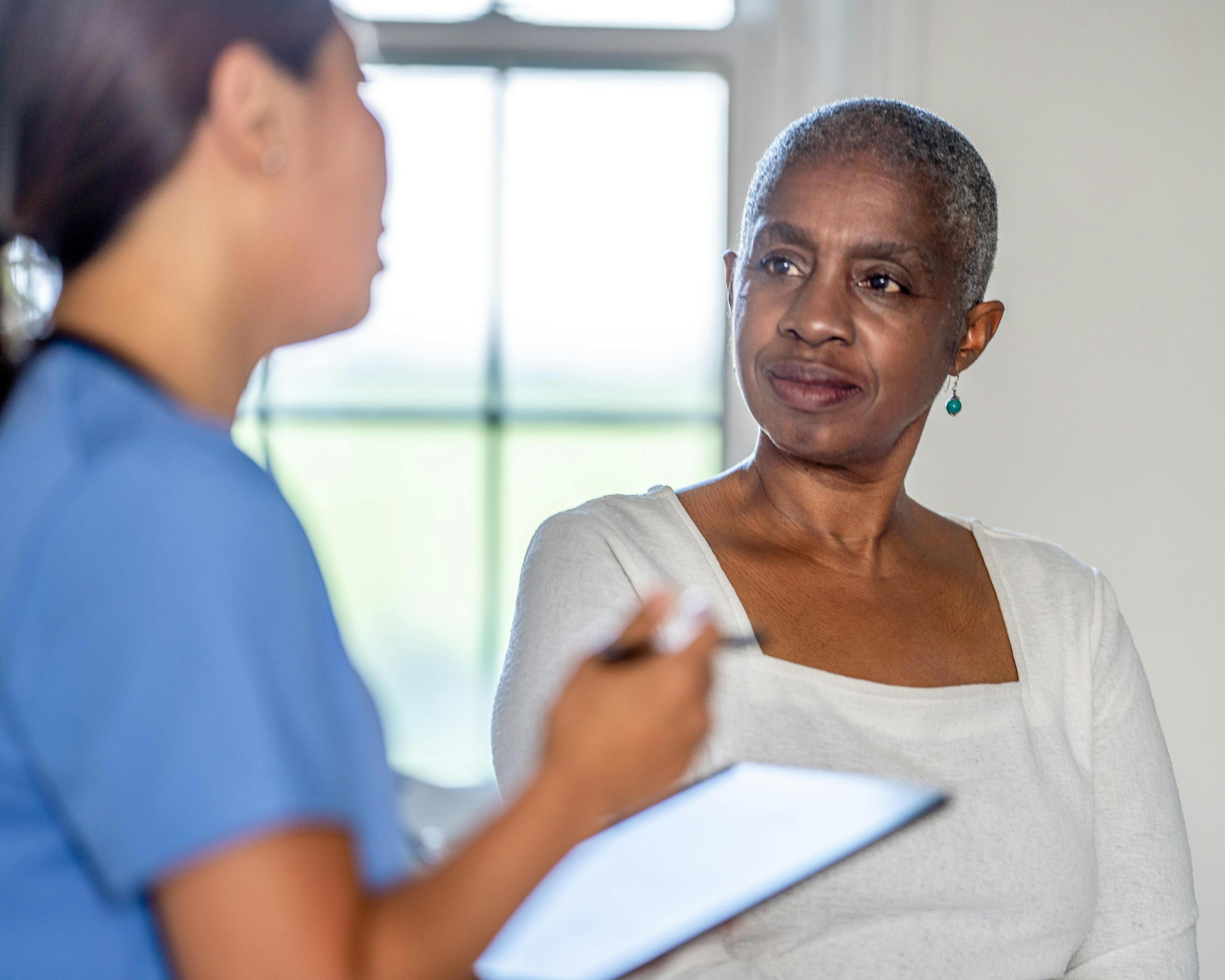 Oncology patient speaking with nurse